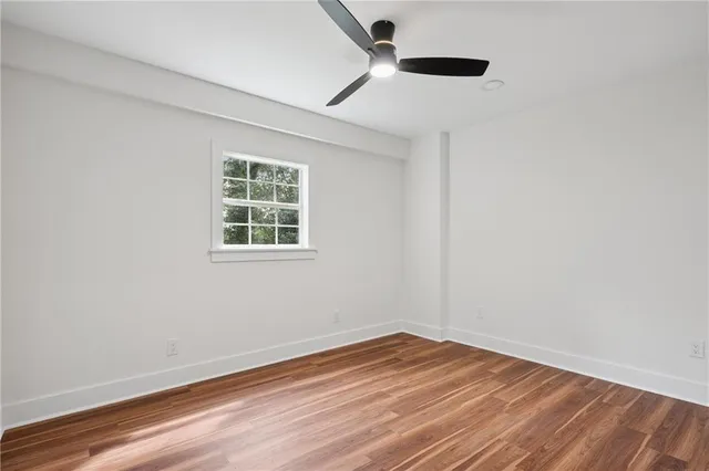 an empty room with wooden floor