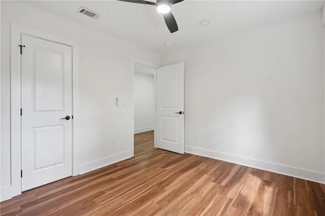 a view of an empty room and wooden floor