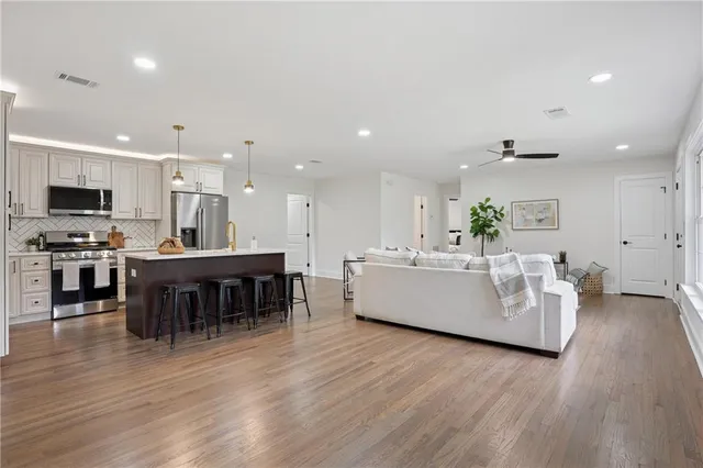 a living room with furniture and kitchen view