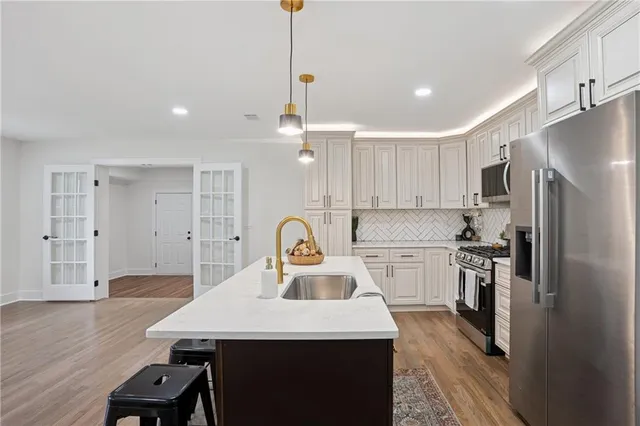 a kitchen with a center island appliances and cabinets