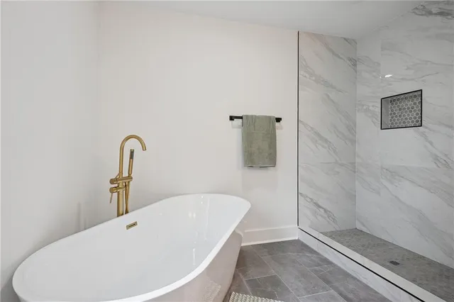 a bathroom with a tub and shower