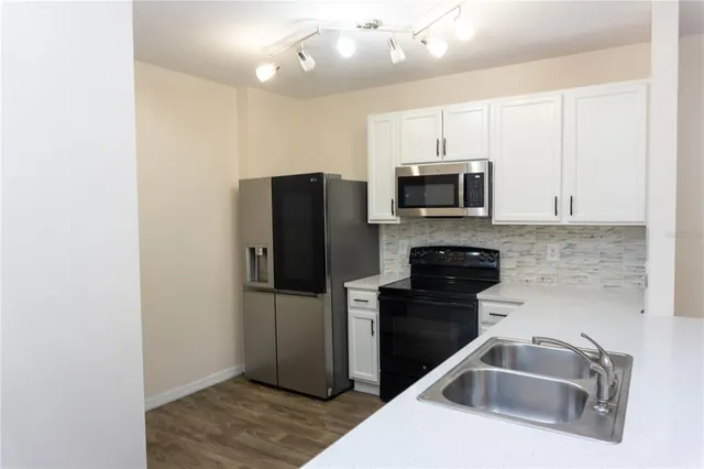 a kitchen with a refrigerator sink and microwave