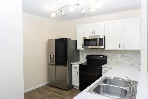 a kitchen with a refrigerator sink and microwave