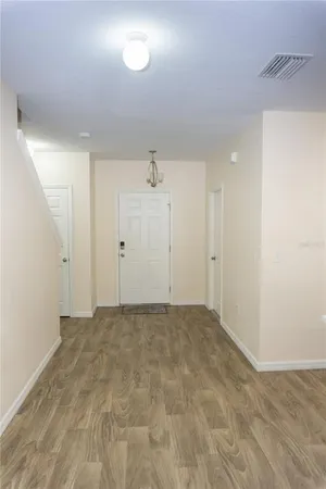 an empty room with wooden floor and closet
