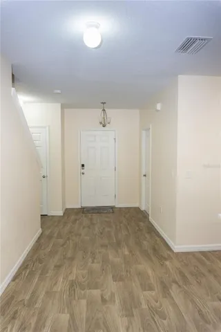 an empty room with wooden floor and closet