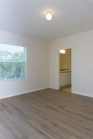 a bathroom with a granite countertop sink a toilet and a mirror
