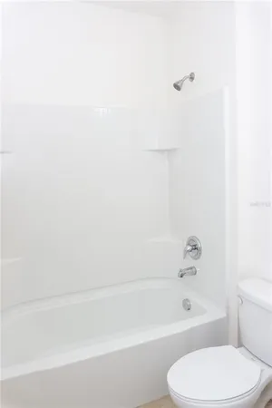 a bathroom with a toilet and bathtub