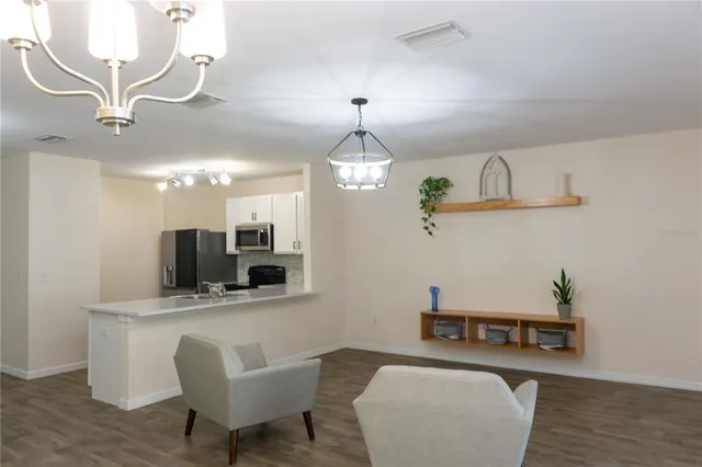 a view of a livingroom with furniture and a flat screen tv