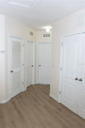 a view of a hallway with wooden floor