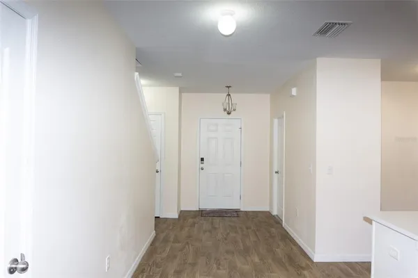 a view of a hallway with wooden floor