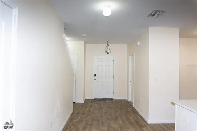 a view of a hallway with wooden floor