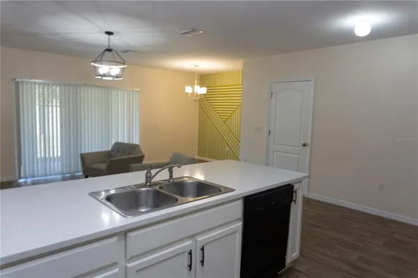 a kitchen with a sink and a refrigerator