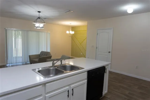 a kitchen with a sink and a refrigerator