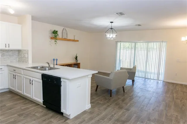 a kitchen that has a sink and a stove in it