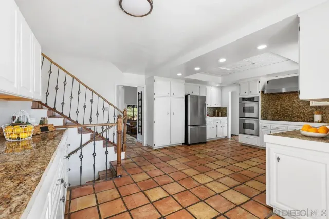 a view of kitchen with furniture and a refrigerator