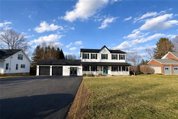 a view of a large building with a big yard and large trees