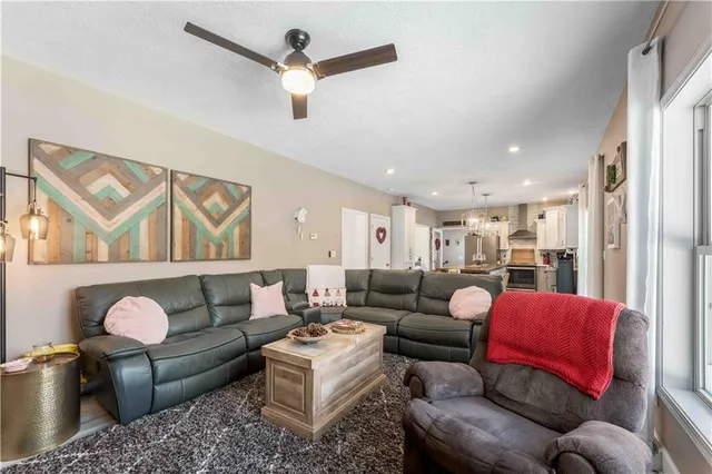 a living room with furniture and a chandelier