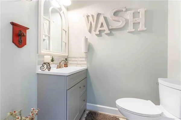 a spacious bathroom with a tub double sink and mirror