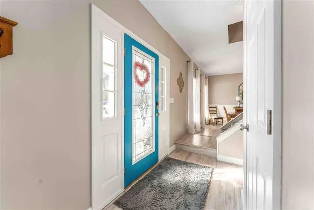 a view of a hallway with windows and plants