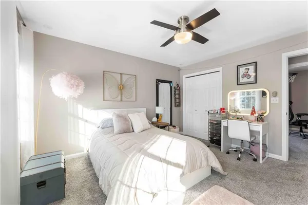 a living room with furniture a flat screen tv and kitchen view