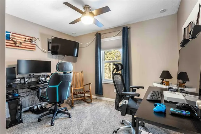 a living room with furniture a flat screen tv and kitchen view