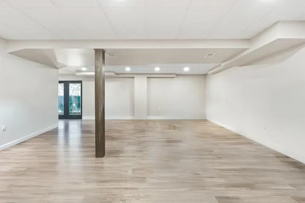 a view of a room with wooden floor and windows