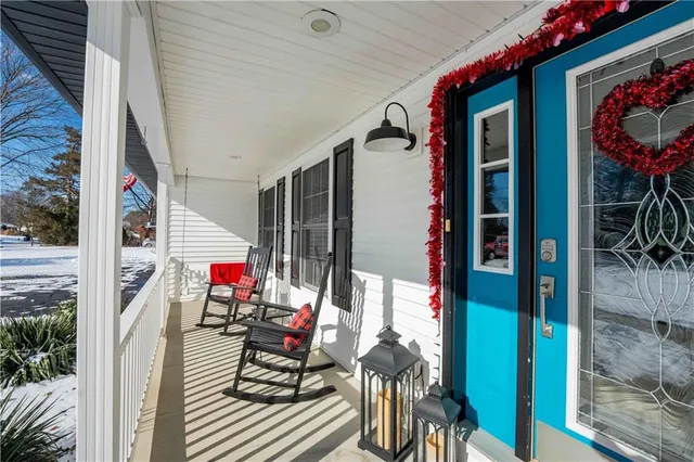 a view of a balcony with chairs and potted plants
