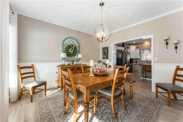 a view of a dining room with furniture wooden floor and chandelier