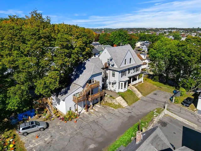 an aerial view of a house with garden space and ocean view