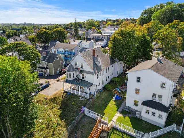an aerial view of a house with a yard and lake view