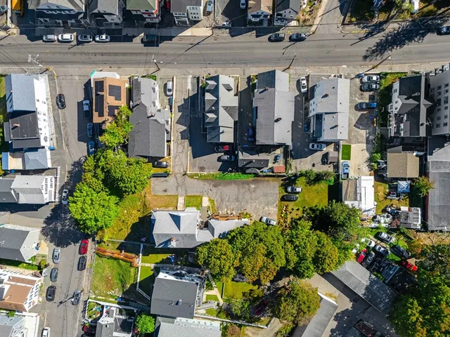 a view of people sitting in front of retail shops