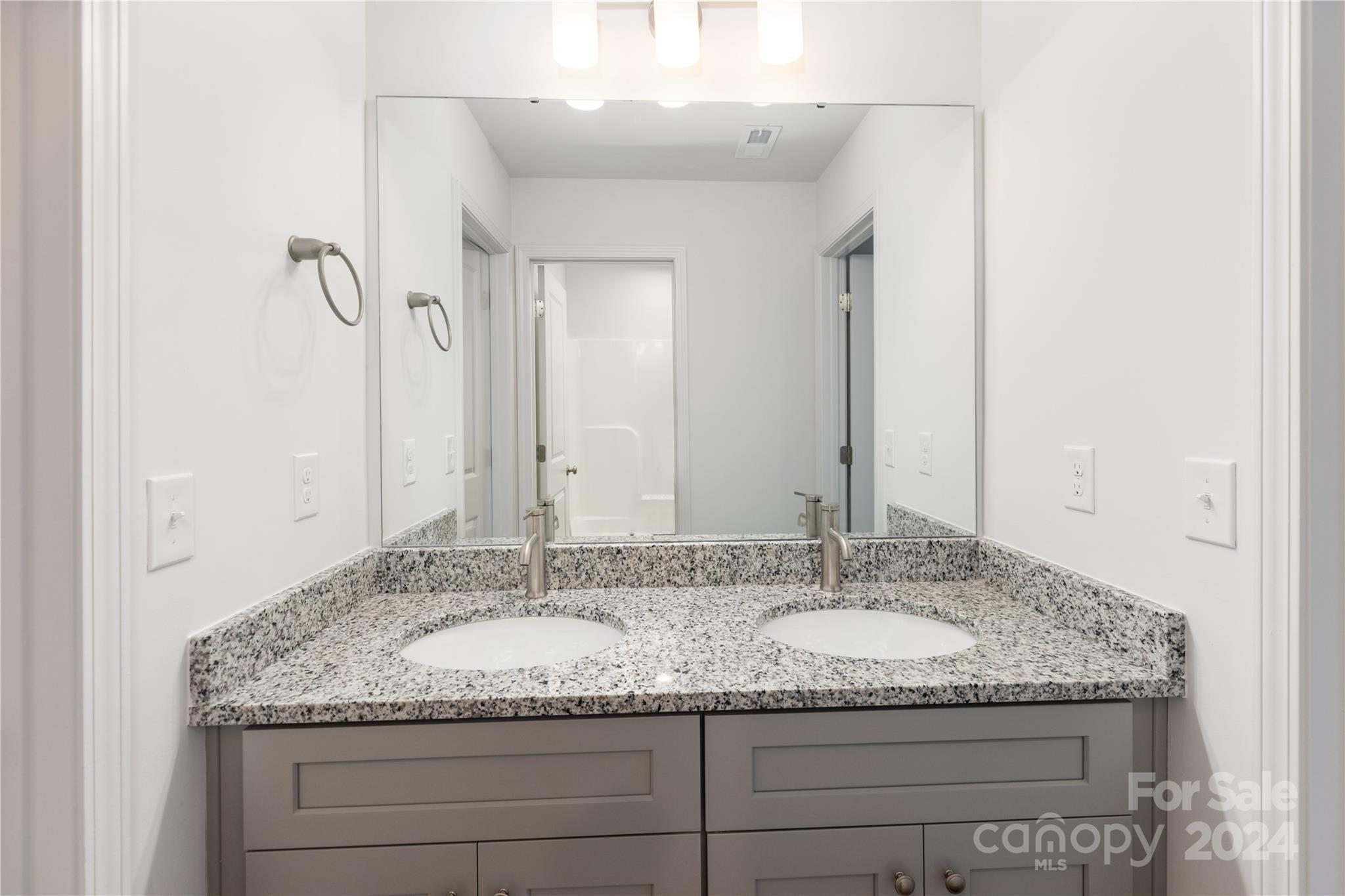 4329 Perkins Road Charlotte, NC 28269 - Photo 19 of 28 a bathroom with a granite countertop sink and a mirror