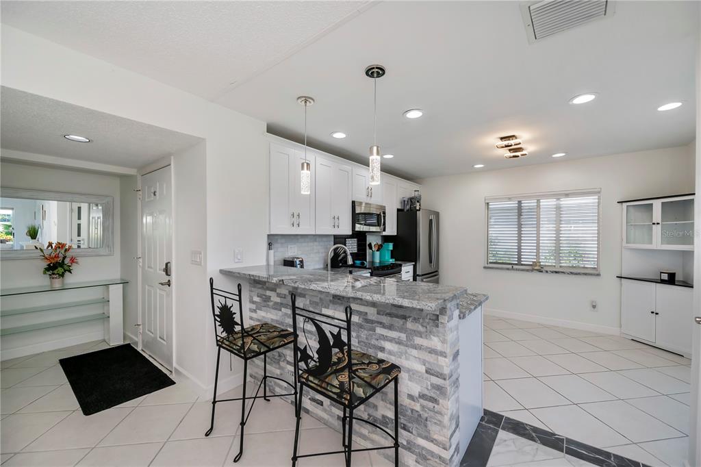 262 Cerromar Way South, Unit 53 Venice, FL 34293 - Photo 22 of 59 a kitchen with stainless steel appliances kitchen island granite countertop a sink and cabinets