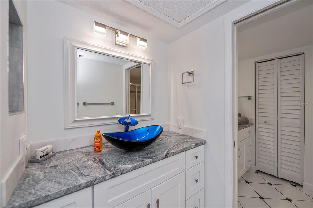 262 Cerromar Way South, Unit 53 Venice, FL 34293 - Photo 33 of 59 a bathroom with a granite countertop sink and a mirror