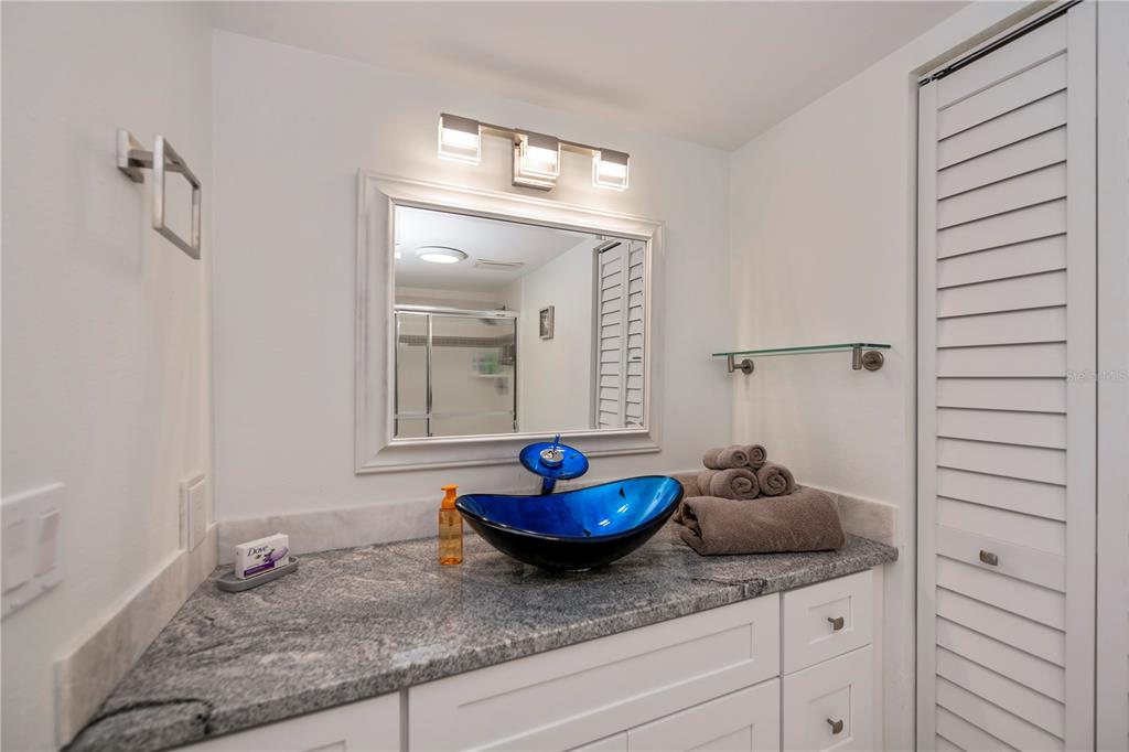 262 Cerromar Way South, Unit 53 Venice, FL 34293 - Photo 34 of 59 a bathroom with a granite countertop sink and a mirror