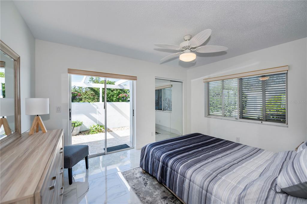 262 Cerromar Way South, Unit 53 Venice, FL 34293 - Photo 40 of 59 a bedroom with a large bed and a chandelier