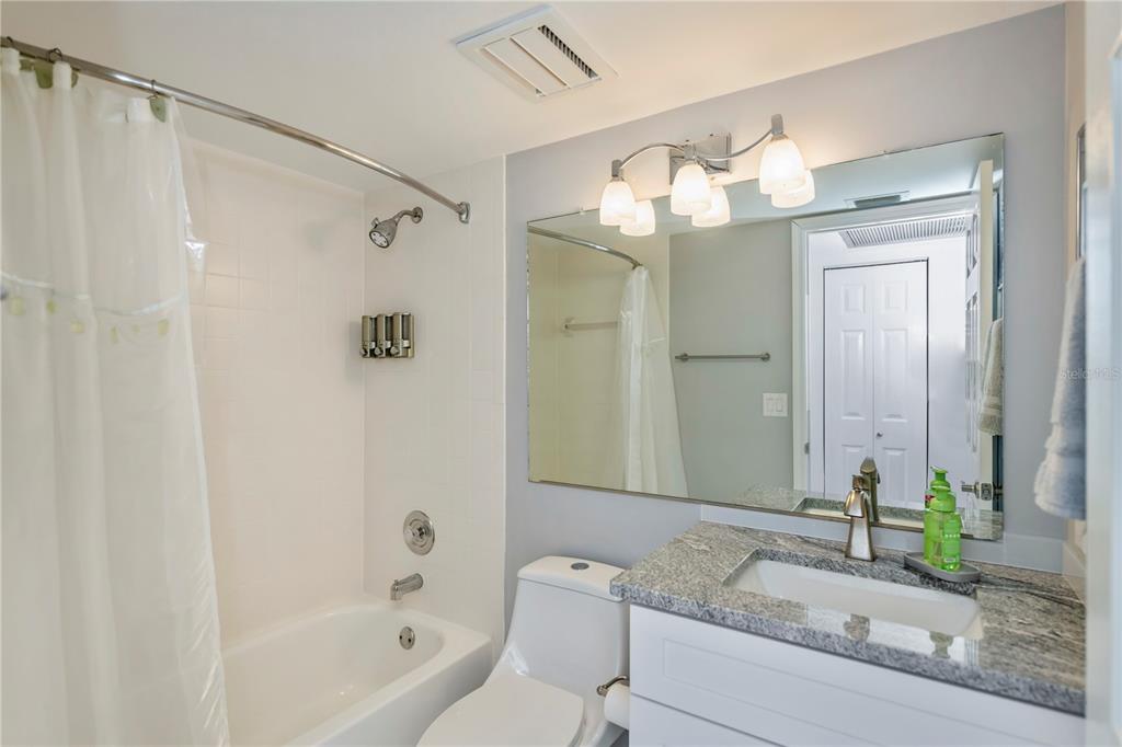 262 Cerromar Way South, Unit 53 Venice, FL 34293 - Photo 44 of 59 a bathroom with a granite countertop sink a mirror and a bathtub