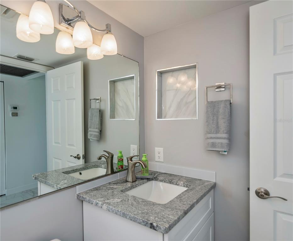 262 Cerromar Way South, Unit 53 Venice, FL 34293 - Photo 45 of 59 a bathroom with a granite countertop double vanity sink and a mirror