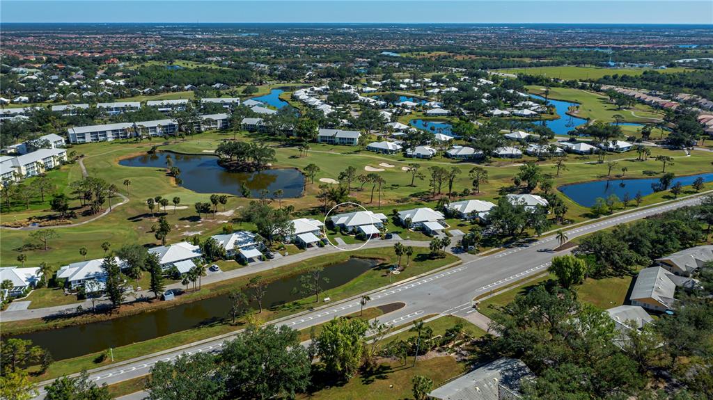 262 Cerromar Way South, Unit 53 Venice, FL 34293 - Photo 5 of 59 an aerial view of lake and residential houses with outdoor space