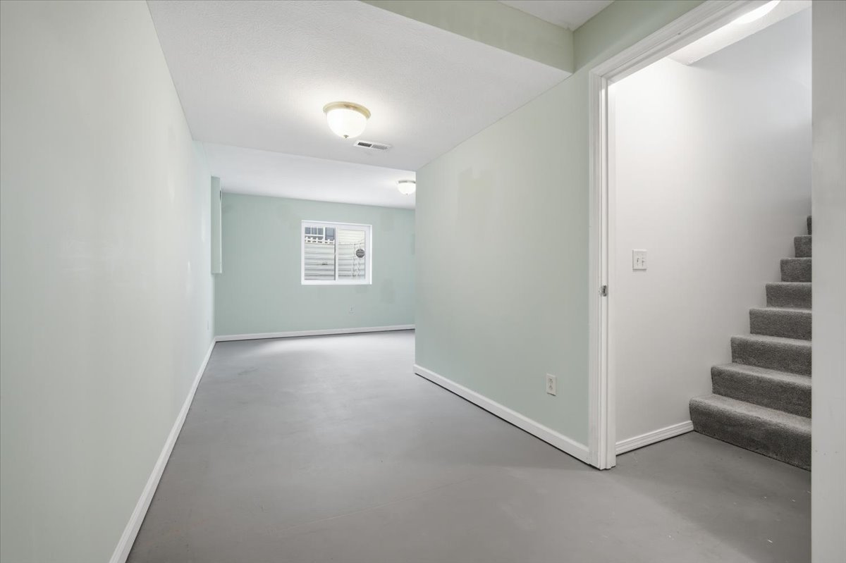 915 Teegan Street Normal, IL 61761 - Photo 23 of 33 an empty room with staircase and white walls