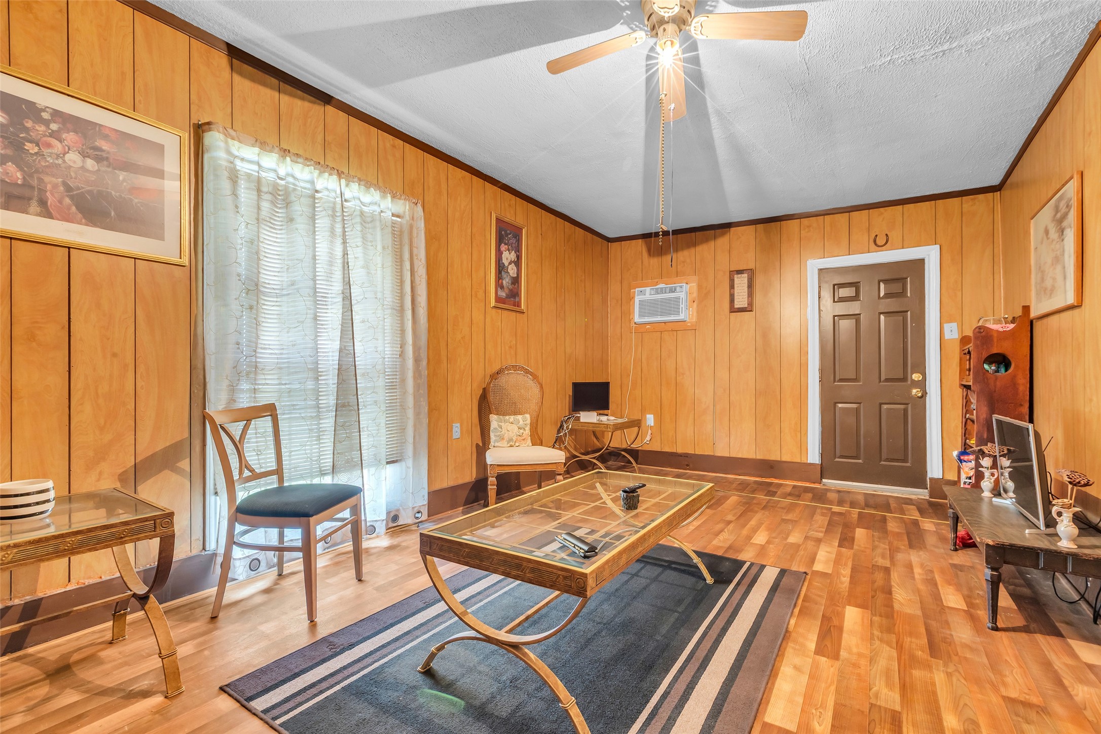 a living room with a bed furniture and a large window