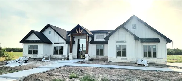 a front view of a house with yard and seating space