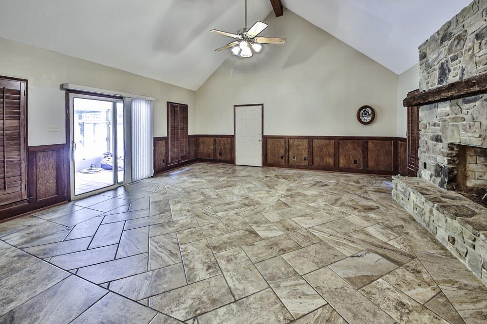 3693 Brunswick Road Bartlett, TN 38133 - Photo 16 of 30 Unfurnished living room with a fireplace, ceiling fan, high vaulted ceiling, beam ceiling, and light tile patterned floors
