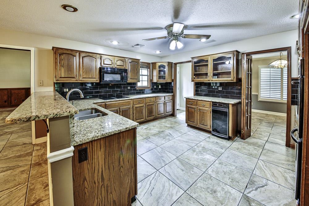 3693 Brunswick Road Bartlett, TN 38133 - Photo 17 of 30 Kitchen featuring black appliances, sink, backsplash, beverage cooler, and ceiling fan
