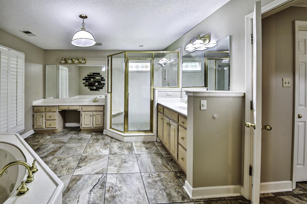 3693 Brunswick Road Bartlett, TN 38133 - Photo 20 of 30 Bathroom with double sink vanity, a textured ceiling, tile patterned flooring, and an enclosed shower