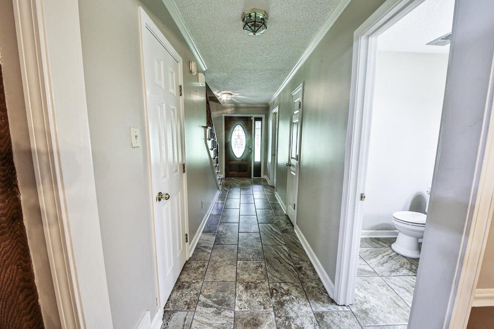 3693 Brunswick Road Bartlett, TN 38133 - Photo 22 of 30 Hallway with tile patterned floors, ornamental molding, and a textured ceiling
