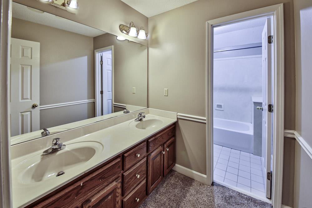 3693 Brunswick Road Bartlett, TN 38133 - Photo 27 of 30 Bathroom featuring tub / shower combination, double sink vanity, and tile patterned flooring