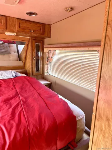 a bed sitting in a bedroom next to a window