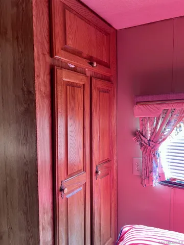 a view of a dry yard with wooden fence
