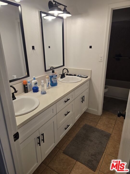 2417 South Budlong Avenue, Unit U#1 R#1 Los Angeles, CA 90007 - Photo 3 of 6 a bathroom with double vanity and two mirror